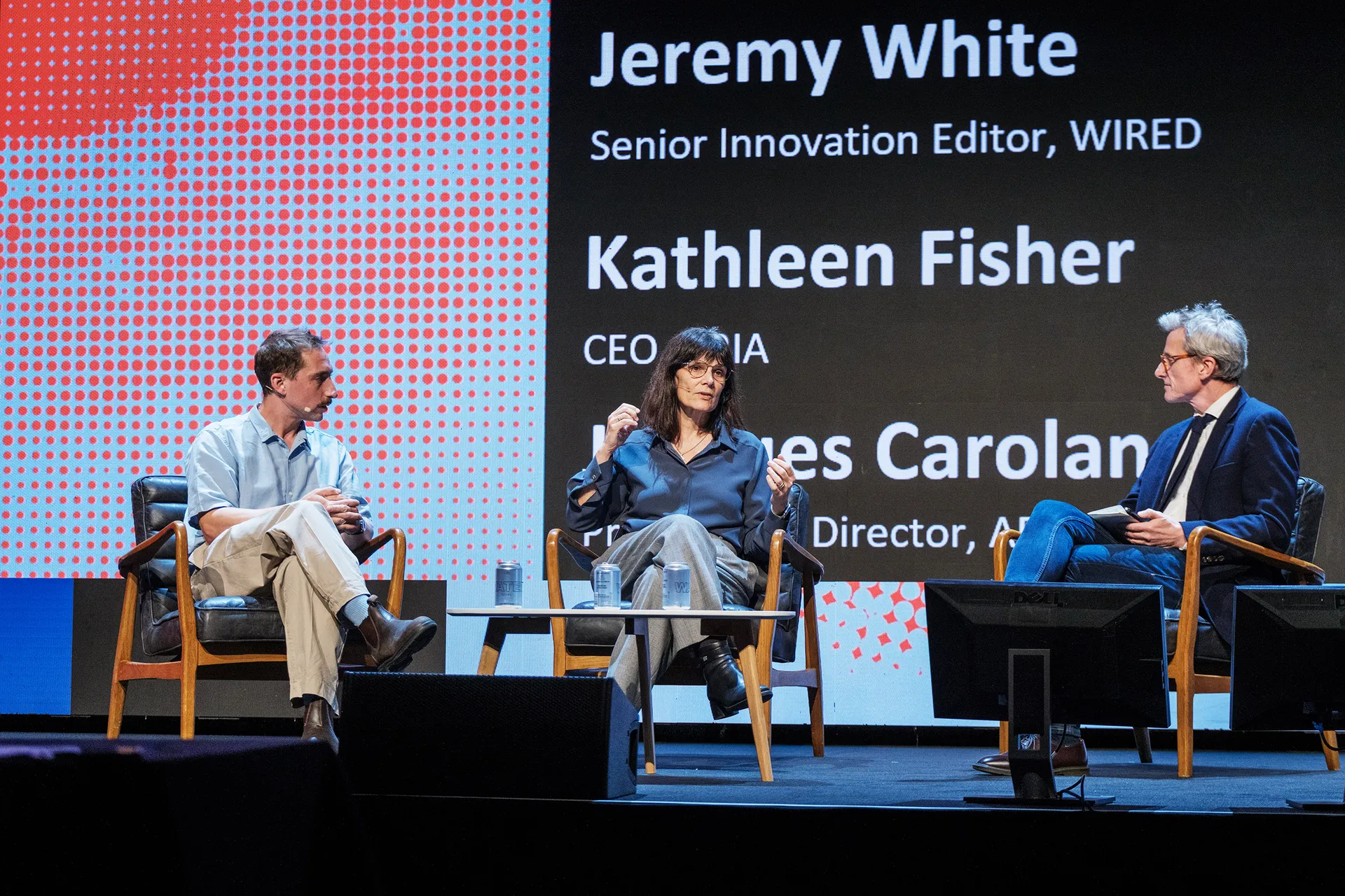 Jacques Carolan and Kathleen Fisher sitting on stage in discussion with Jeremy White from Wired Health