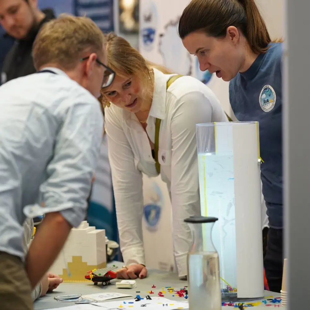 A group of people watching an experiment at Greenland Science Week