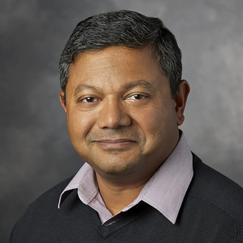 Headshot of Arun Majumdar against a grey background
